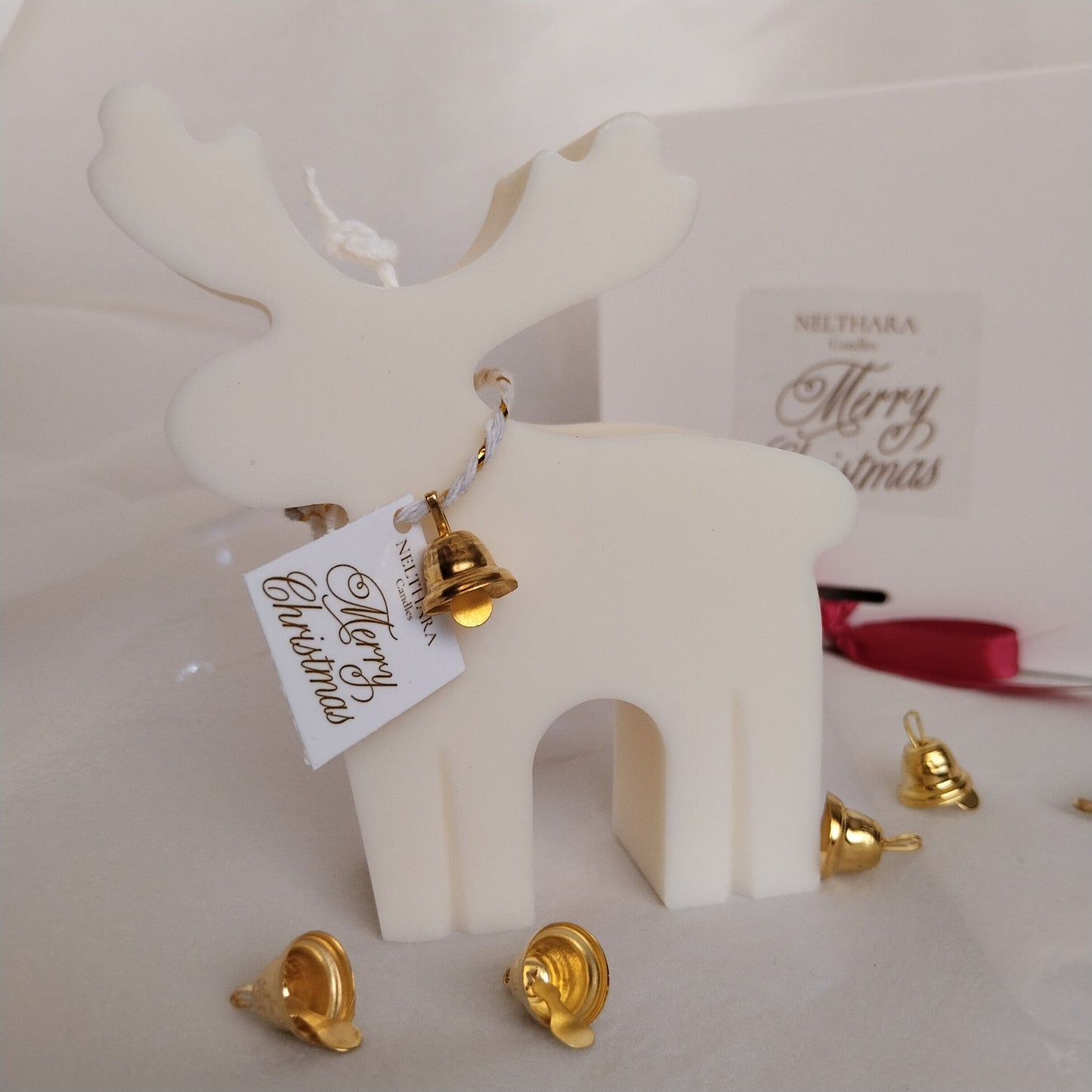 Vela artesanal en forma de reno navideño con lacito y campana dorada, decoración minimalista y elegante para Navidad. Ideal regalo Navideño.